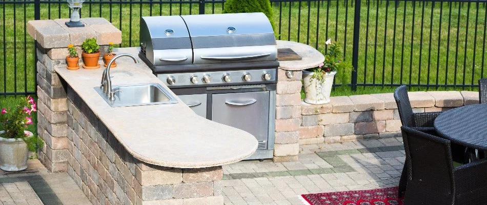 Outdoor kitchen in Louisville, KY, with a grill and sink.