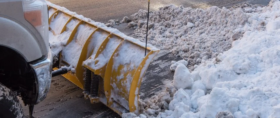 Snowy, icy road in Louisville, KY, being plowed.