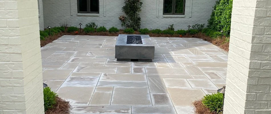 Modern patio with a sleek design and a central water feature in Louisville, KY.