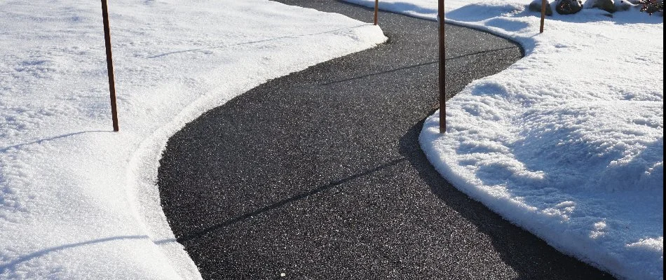 Cleared sidewalk in Louisville, KY, with snow surrounding it.