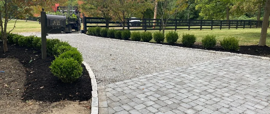 Driveway in Beechwood Village, KY, lined with green shrubs.