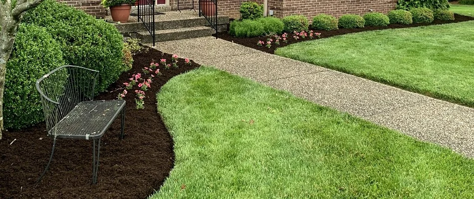 Front of home with mulch landscape bed and bench in Louisville, KY.