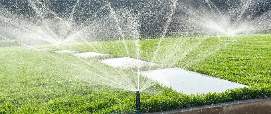 Lawn in Louisville, KY, with running sprinkler heads.