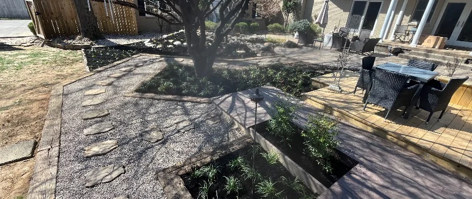 Outdoor space in Douglass Hills, KY, with landscaping, trees, plants, walkway, and patio.