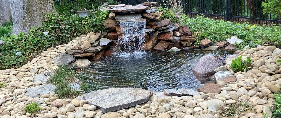 Rocks around a waterfall with a pond in Watterson Park, KY.