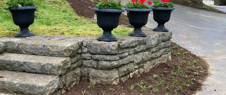 Stone retaining wall with planters and steps in Louisville, KY.