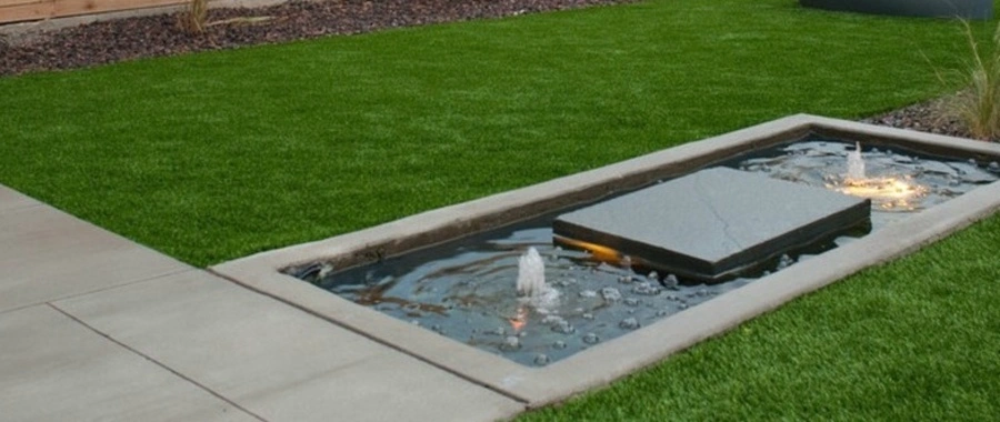 Water feature in Louisville, KY, with rocks and plants.